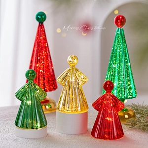 Illuminated glass Christmas tree ornaments with LED lights on a white cylinder base