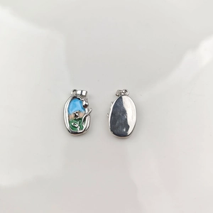 Detail of oil painting style enamel flower pendants with polished silver backings