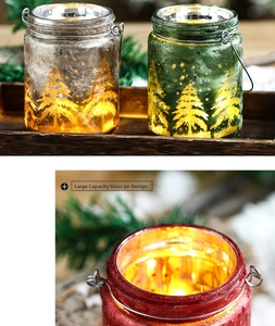 Close-up of frosted glass jar with pine tree pattern and warm light for Christmas