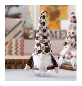 Christmas gnome coffee jar with plaid knit hat and white beard in a cozy holiday setting