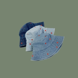 Three denim bucket hats in dark, medium, and light blue with red heart embroidery detail