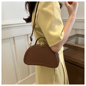 Brown semi-circular saddle bag with quilted V-pattern, handheld or crossbody style