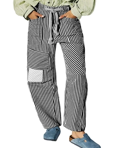 Detail of loose striped trousers with drawstring waist and patchwork pocket texture