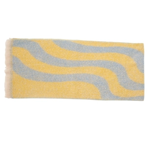 Detailed view of yellow and blue wave pattern knit scarf with fringe trim textures