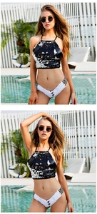 Detailansicht der weißen Denim-Hotpants mit LOVE VE Print und Fransen für Sommer-Strandpartys