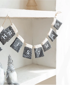 Close-up of gray velvet Christmas bunting with white faux fur trim and sequin details