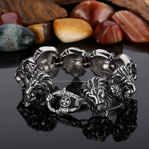 Detailed close-up of wild lion head stainless steel links on a rugged men's bracelet