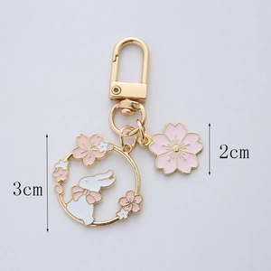 Detail view of cherry blossom rabbit keychain with 3cm and 2cm size measurements