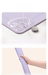Detail of purple silicone baking mat showing raised spill-proof edge and measurement scales