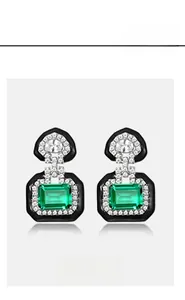 Macro shot of S925 silver emerald stud earrings with geometric halo and micro-pavé diamonds