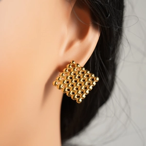 Elegant gold minimalist woven bead stud earrings shown on model ear for a modern look
