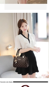 Detailed view of large brown handbag with gold patterns and brand logo on inner side
