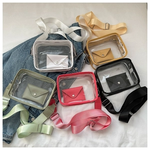 Flat lay of transparent PVC crossbody bags with wide straps in five vibrant colors