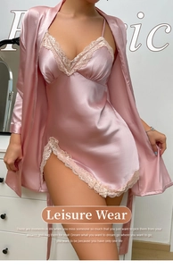 Detail of pink satin sleepwear set with beige lace trim and elegant side slit design