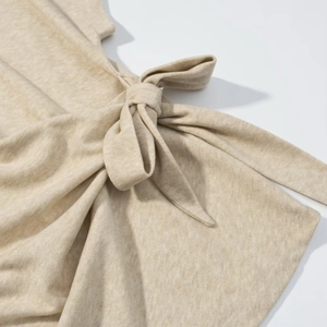 Macro shot of knitted fabric showing the side knot bow detail on the skirt set