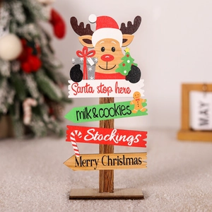 Detail of wooden 'Santa Stop Here' Christmas desktop sign with reindeer and candy cane