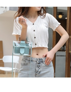 Mini transparent mint blue PVC crossbody bag held by a model in casual summer attire