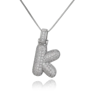 Macro shot of silver letter K pendant with micro-pave cubic zirconia on box chain