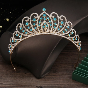 Detailed view of golden crown with blue crystals and rhinestones for weddings