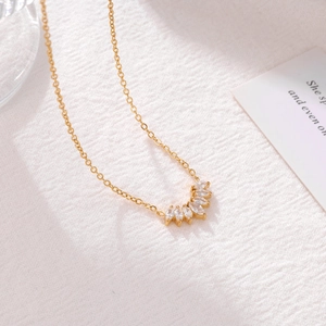 Elegant gold chain necklace featuring a Marquise zircon petal pendant on a white fabric base