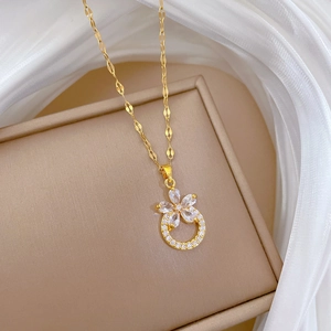 Close-up of a gold flower pendant with sparkling zircons and a micro-paved crystal ring