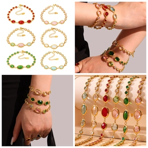 Detail view of multi-color oval gemstone bracelets with gold plated stainless steel chain