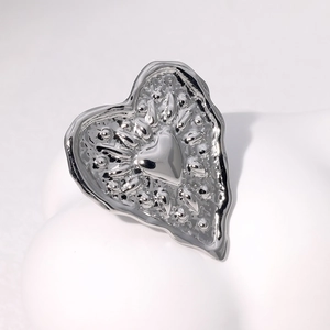 Minimalist silver heart ring in liquid metal style on a clean white background