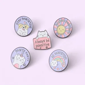 Set of five cute cat and dog enamel pins with positive quotes on a purple background
