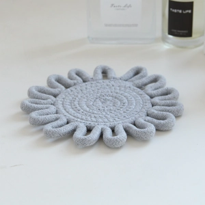 Detailed view of grey hand-woven cotton rope coaster with intricate looped edge craft