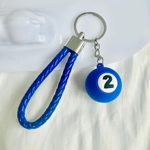 Detail of blue number 2 billiard ball keychain with braided leather strap for accessories