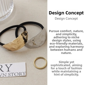 Detail of hammer textured gold and silver hair ties with a minimalist thin metal ring
