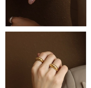 Macro shot of French vintage golden twisted croissant rings in polished stainless steel