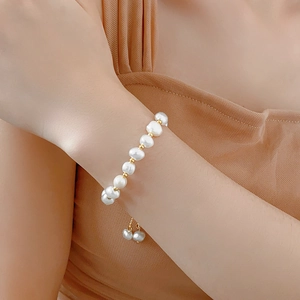 Close-up of elegant baroque pearl bracelet with gold beads and adjustable gold chain