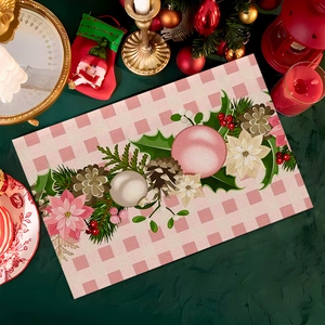 Close-up of heat-resistant Christmas placemat with pink plaid, pinecones, and festive patterns