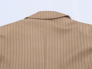 Detail of pinstriped linen blend blazer showing neck stitching and fabric texture