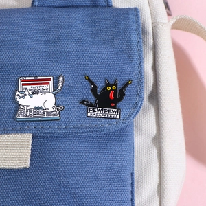 Cute enamel cat pins featuring a laptop white cat and black cat with pew pew text
