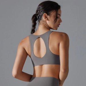 Detail of the high-stretch racerback sports bra with stylish oval back cutout in grey