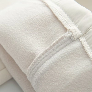 Detailed macro view of the warm cream fleece lining for a women's waterproof ski suit