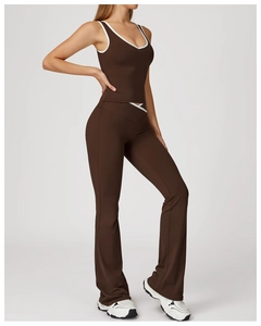 Detail of cross high-waist flared yoga pants and v-neck sports top with white contrast trim