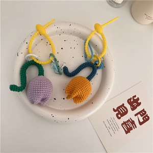 Detailed knit texture of handmade purple and orange tulip charms with silicone strap