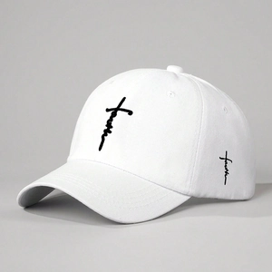 White cotton baseball cap with black faith embroidery and cross detail, 45-degree studio view
