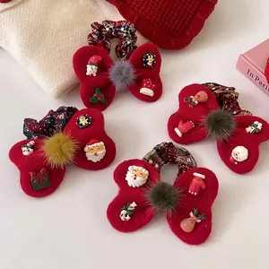 Christmas bow scrunchie with red plush material, plaid patterns and holiday ornaments