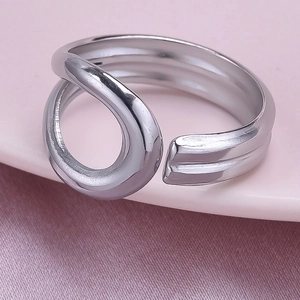 Macro detail of silver adjustable geometric ring with polished abstract layered design