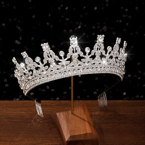 Detailed close-up of a silver rhinestone bridal crown showing intricate hollow floral patterns