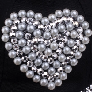 Baseball cap with heart-shaped pearl and rhinestone decoration on black fabric