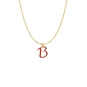 Macro shot of gold-plated necklace featuring a letter B pendant with red enamel inlay