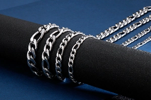 Close-up of silver stainless steel NK chains in four widths on a professional stand