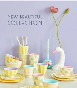Detail of macaron pastel tableware set with polka dots and stripes on a light purple surface