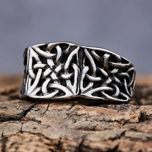 Vintage Celtic knot ring in silver finish with embossed patterns on tree bark background