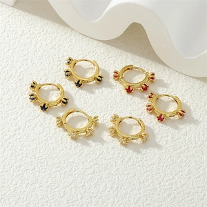 Detailed view of 18K gold plated hoop earrings with vibrant blue red and white cubic zirconia